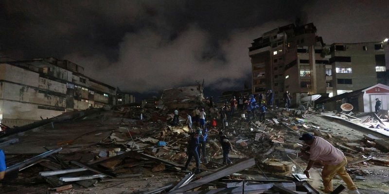 Rescue workers search through the rubble after an earthquake in Caracas, Venezuela, Wednesday, June 24, 2026. (AP Photo/Javier Campos)