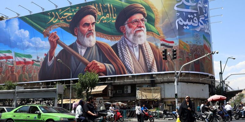 epa13021861 Iranians walk past a huge billboard featuring late Iranian Supreme Leader Ayatollah Ruhollah Khomeini and Supreme Leader Ayatollah Ali Khamenei on a street in Tehran, Iran, 07 June 2026. Pakistan's Interior Minister Mohsin Naqvi is in Tehran to deliver messages from Pakistan's leadership to Iranian officials amid ongoing US-Iran tensions.  EPA/ABEDIN TAHERKENAREH RESTRICTIONS: NO Access Israel Media/Persian Language TV Stations Outside Iran/Strictly No Access BBC Persian/VOA Persian/Manoto TV/Iran International TV. (As mandated by Iran's Directorate General for Foreign Media) --